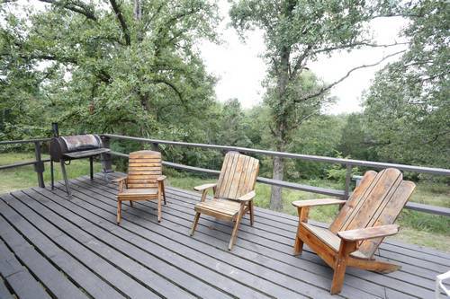 Back porch with barbecue grill and lawn chairs