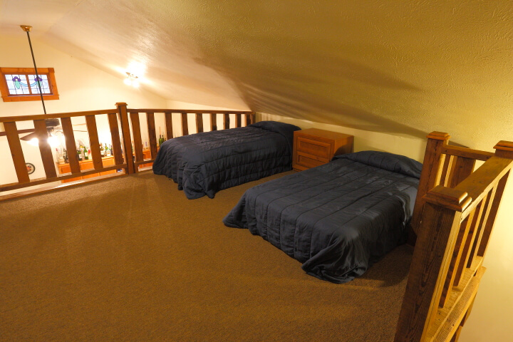 Upstairs bedroom area with two beds