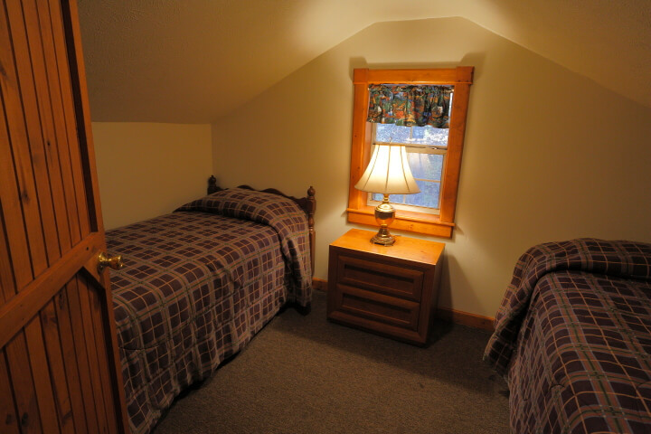 Another sleeping area upstairs with two beds